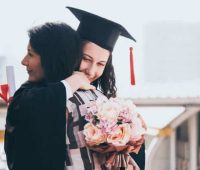 Beautiful woman congratulates for her daughter on graduation day, Successful concept